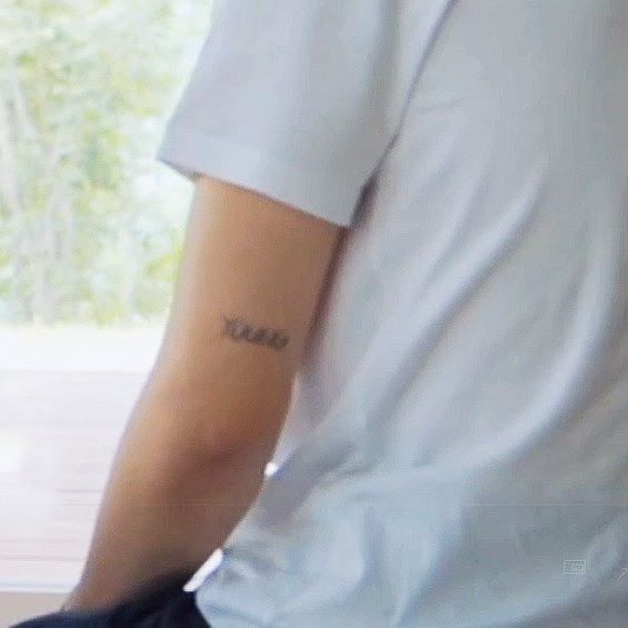 The number 13 tattooed on his hand symbolizes his belief and good luck. Check out the image to admire the gentle and masculine features of the BTS idol.\