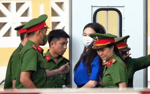 Cận cảnh Thuỳ Tiên bị còng tay áp giải đến toà, mặc áo màu xanh đặc biệt gây chú ý - Hình 1