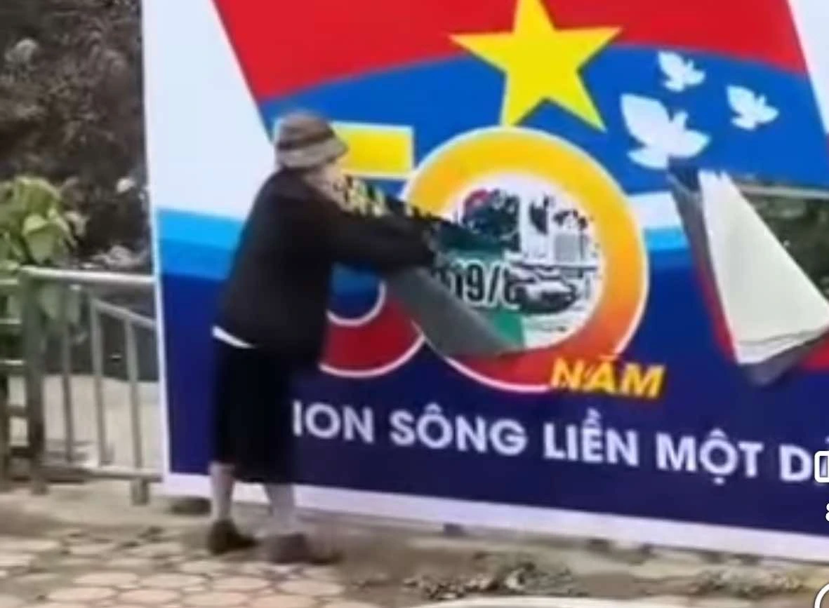 Vụ rạch banner đại lễ 30/4: người phụ nữ lộ biểu cảm lạ tại cơ quan CA - Hình 2